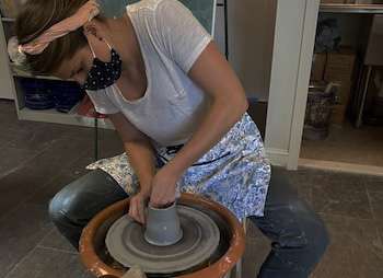 Teacher Megan Hollerbach at the ceramics wheel